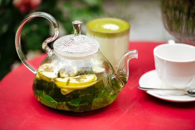 closeup on glass teapot with green mint tea and cup 219193 4029